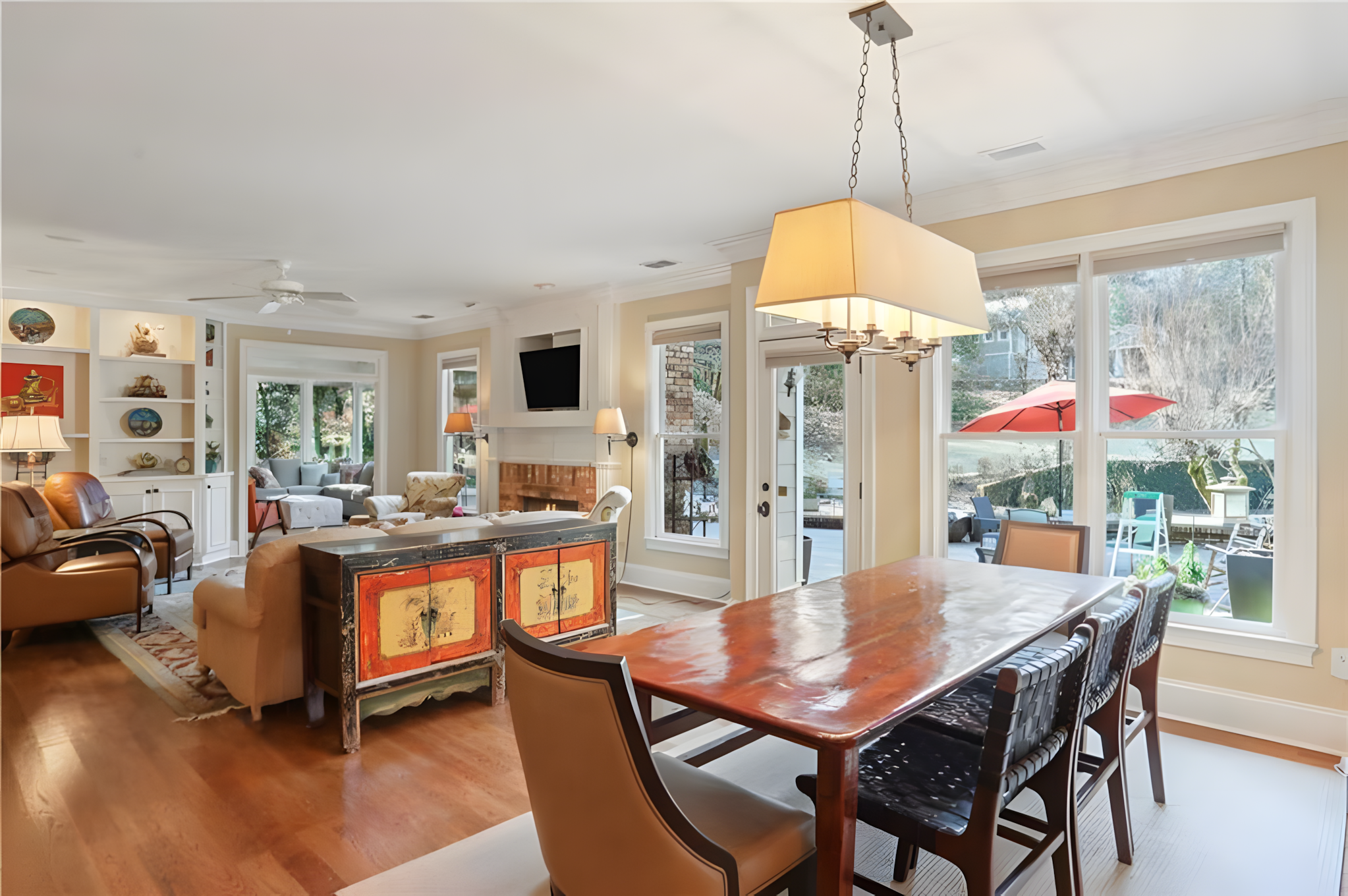 kitchen dining table next to living room area with back porch in view