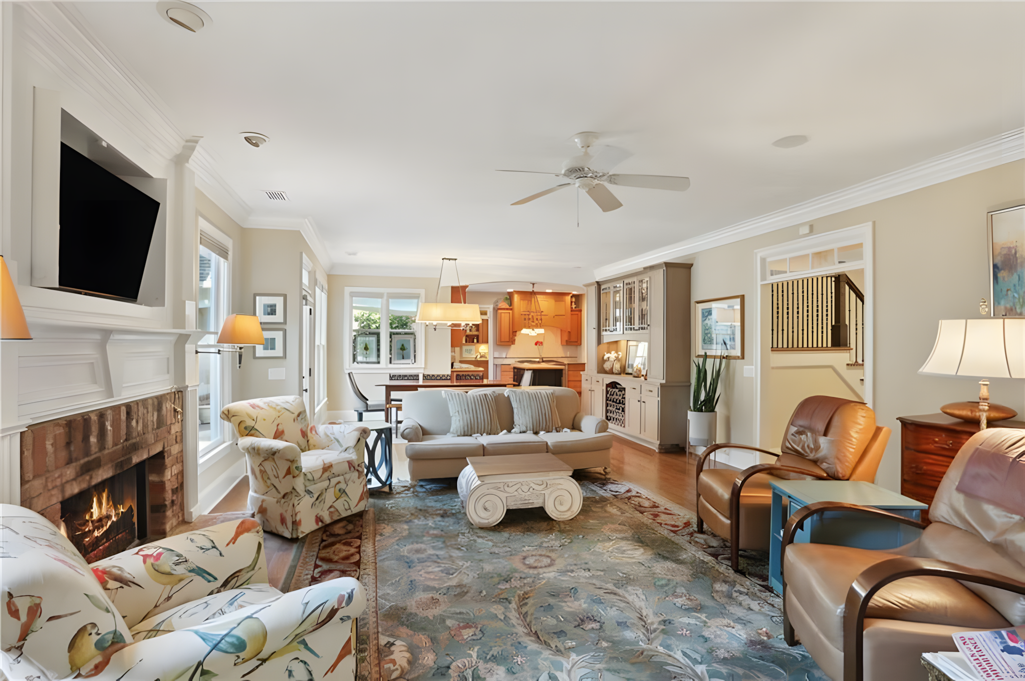 living room areas with patterned sofas and dining table and kitchen in view