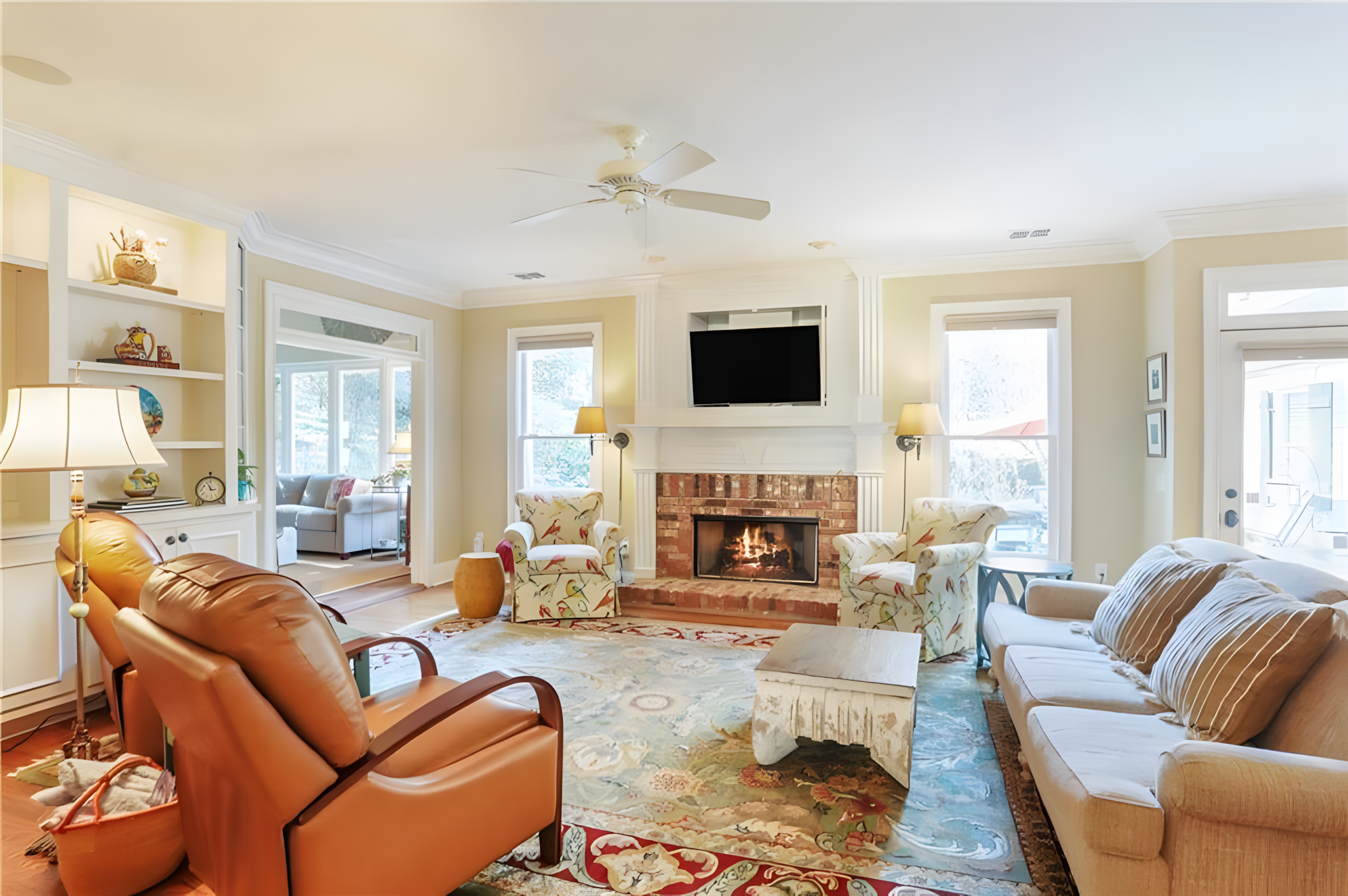living room fireplace with red brick surround and white mantel