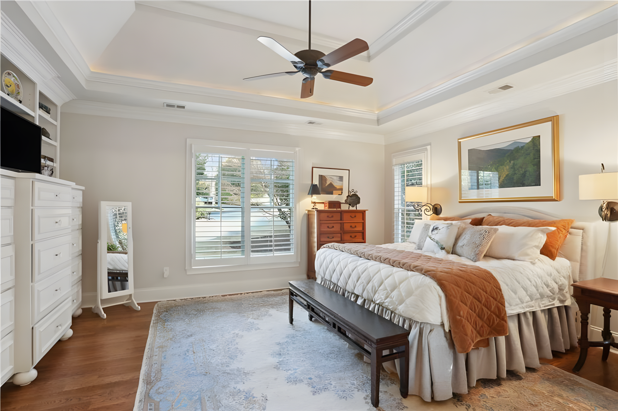 bedroom with ceiling fan and blue antique rug