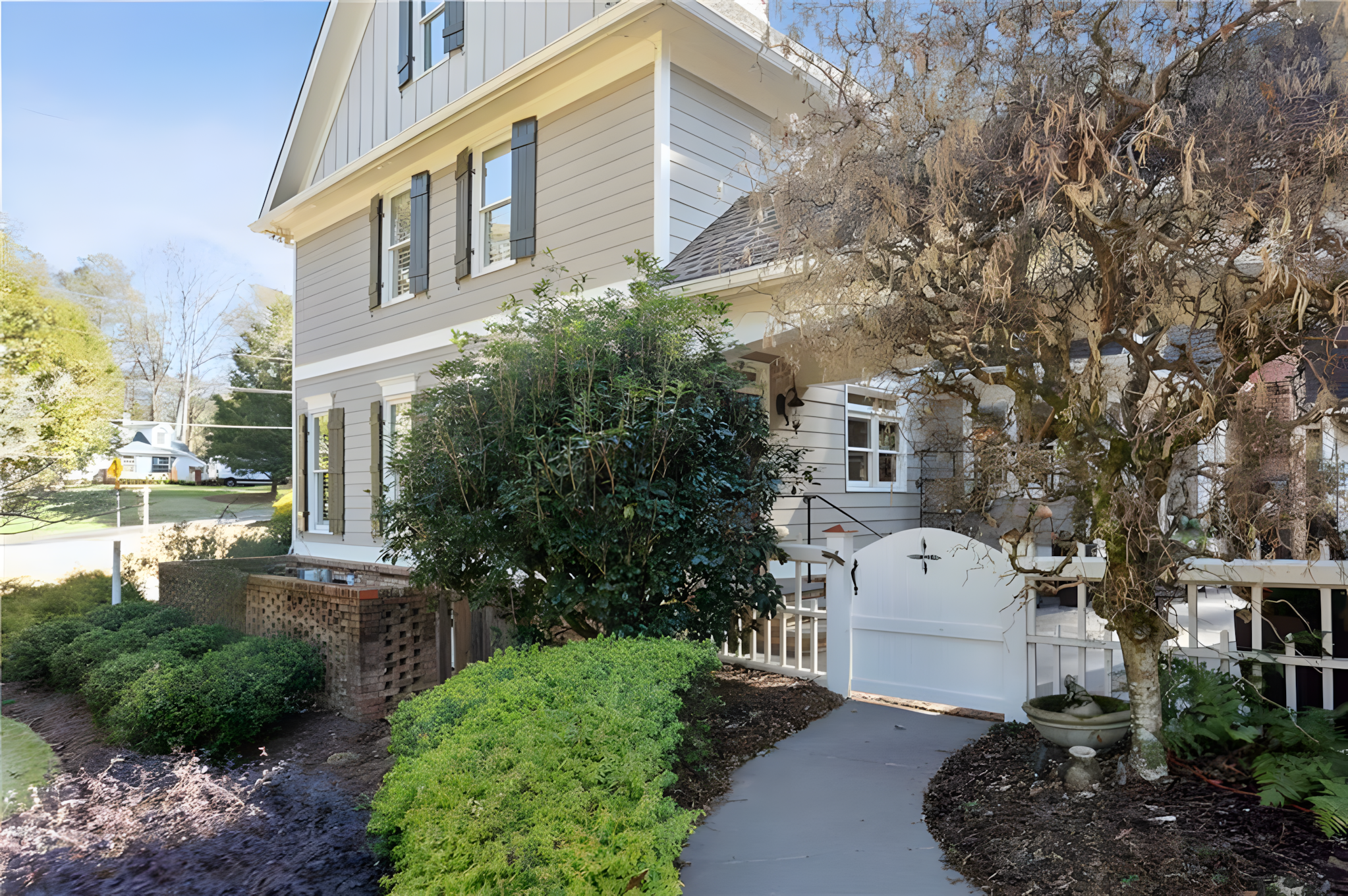 side exterior of home with white gate