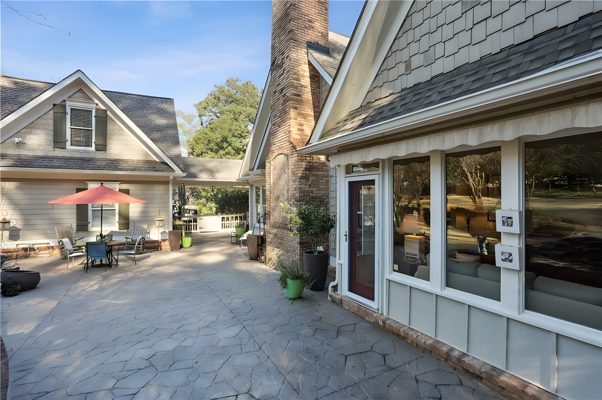 back porch with exterior of stone fireplace and screened porch in view
