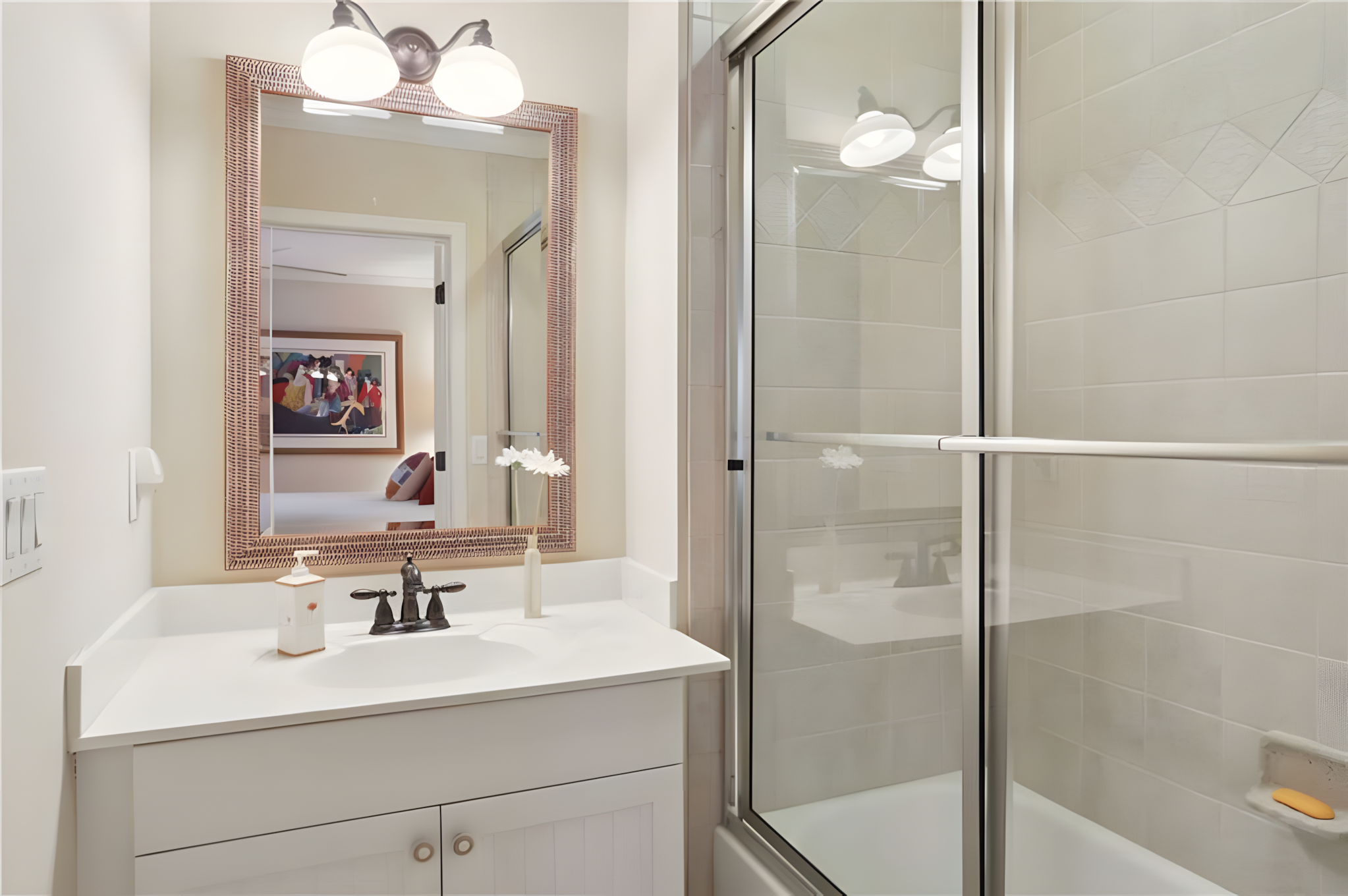 bathroom with tub shower and white sink cabinet