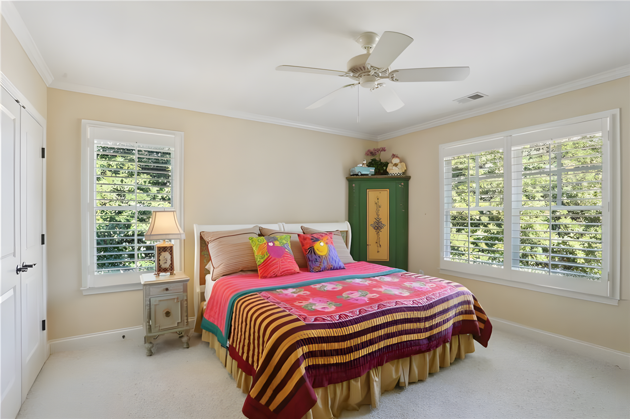 bedroom with red covered mattress and green corner dresser